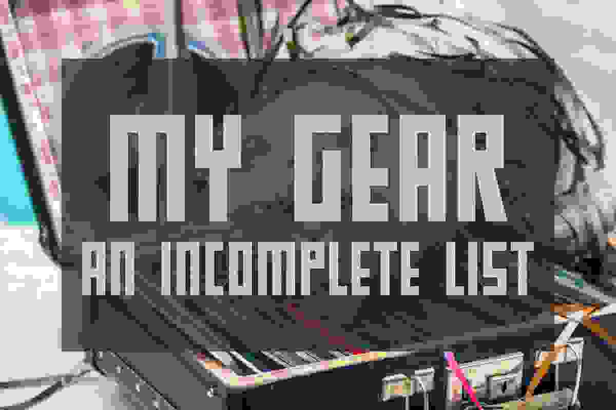 Cat lying on suitcase with old music tape reels. Text overlay says My Gear An Incomplete List.